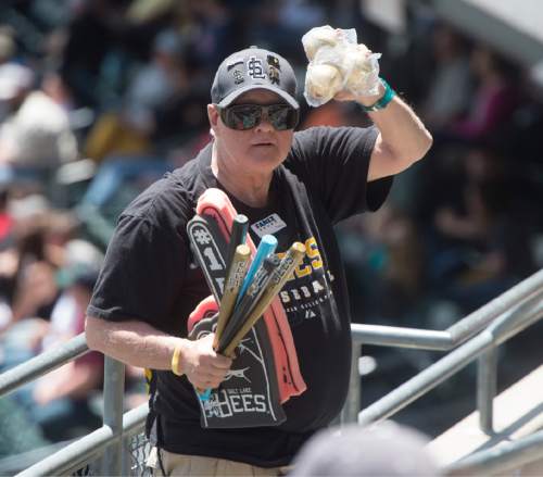 Rick Egan  |  The Salt Lake Tribune

Paul Watson sells souvenir bats, baseballs, and foam fingers, at the Salt Lake Bees game, Thursday, May 28, 2015. Watson has selling programs, souvenirs, and peanuts at sporting events for 27 years.