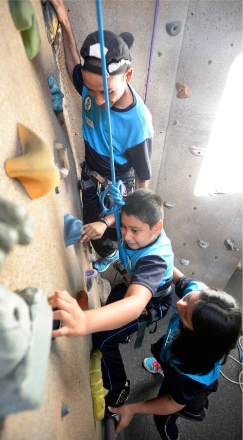Al Hartmann  |  The Salt Lake Tribune
Emilio Palacios Diaz, 12, from El Salvador reaches for a hand hold to climb the climbing wall at the National Abilty Center in Park City.   He has Spina Bifida and has limited use of his legs.  He is spotted by instructors from El Salvador who have been trained to work with youth from their country as part of the SportsUnited program.