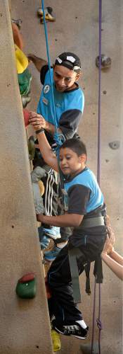 Al Hartmann  |  The Salt Lake Tribune
Emilio Palacios Diaz, 12, from El Salvador reaches for a hand hold to climb the climbing wall at the National Abilty Center in Park City.   He has Spina Bifida and has limited use of his legs.  He is spotted by instructor Jose Carlos Guardardo from El Salvador who have been trained to work with youth from his country as part of the SportsUnited program.