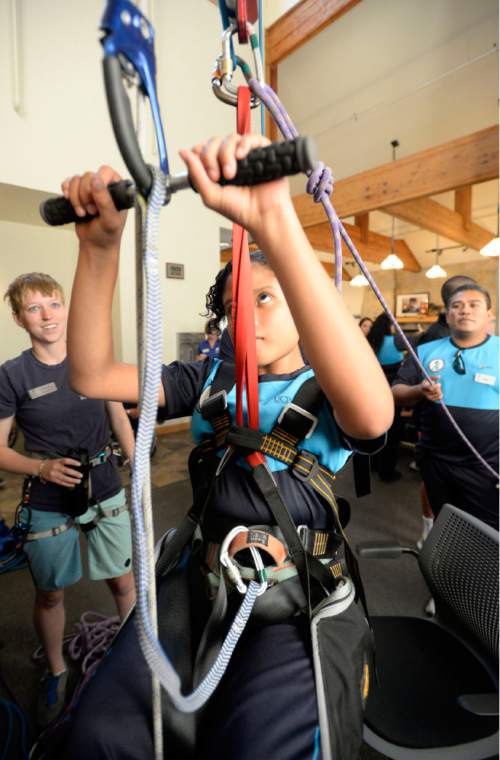 Al Hartmann  |  The Salt Lake Tribune
Andrea Guadalupe, 12, from El Salvador uses a safety harness and 4 to 1 pully system to ascend a rope at the National Abilty Center in Park City using just her arms.    She has Spina Bifida and has no use of her legs.   A group of instructors from El Salvador have been trained to work with youth from their country as part of the SportsUnited program.
