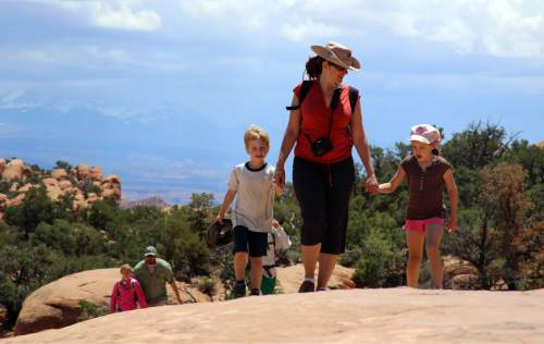 Francisco Kjolseth  |  The Salt Lake Tribune
Toni Schmader, center, is joined by her son Hazen Bedke, 4, and Mira Tueller, 5, as they walk the Devils Garden trail in search of Arches.