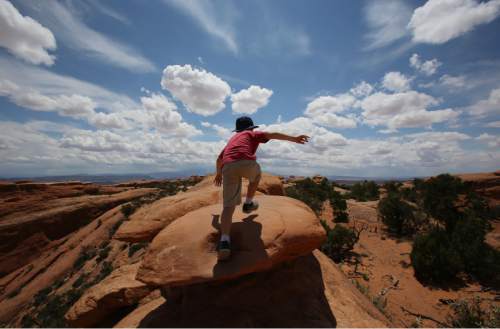Francisco Kjolseth  |  The Salt Lake Tribune
Teo Droguett, 8, steps into the vast landscape that delights visitors from around the world every year at Arches National Park.
