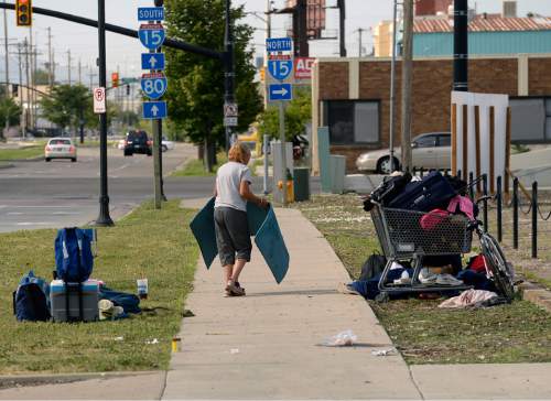 Al Hartmann  |  The Salt Lake Tribune
Homeless woman breaks down her camp near 500 W. and 350 S. in Salt Lake City.   She is among a new group of homeless who are camping out on the 500 West Commons just west of the Rio Grande Depot and a block or two south of the shelter.