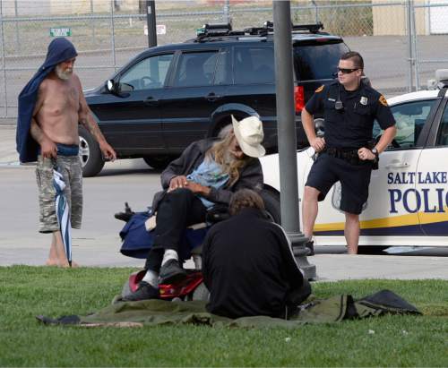 Al Hartmann  |  The Salt Lake Tribune
Salt Lake Police monitor the new group of homeless who are camping out on the 500 West Commons just west of the Rio Grande Depot and a block or two south of the shelter.