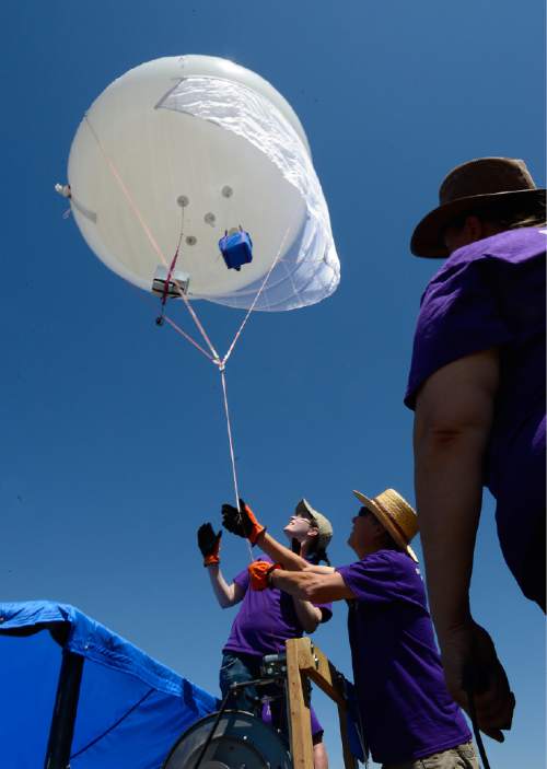 Scott Sommerdorf   |  The Salt Lake Tribune
Murielle Shallbetter, center, and Bill Dowell, second from right, help bring in the weather balloon after a series of test were made, Thursday, July 16, 2015. WSU and the U are conducting a joint study on the impact of the Great Salt Lake on ozone levels on the Wasatch Front. Previous studies have found that salt from the Great Salt Lake contributes to a lot of our wintertime PM 2.5 pollution. The theory is that maybe the lake also contributes to ozone.