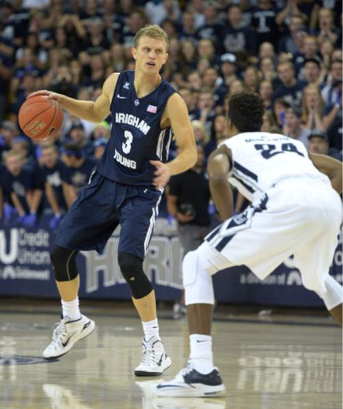 Steve Griffin  |  The Salt Lake Tribune

Brigham Young Cougars guard Tyler Haws (3) looks to drove on Utah State Aggies guard JoJo McGlaston (24) during first half action in the BYU versus USU men's basketball game in Logan, Tuesday, December 2, 2014.