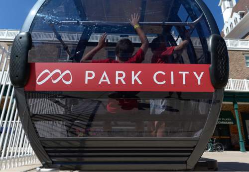 Francisco Kjolseth | The Salt Lake Tribune
A gondola reveals a combination of the two logo's from Park City and the Canyons that will soon be the norm during a press announcement on Wednesday, July 29, 2015, in Park City. Last season, Vail Resorts announced a $50 million capital improvement project to connect Park City Mountain Resort and Canyons Resort, creating the largest single ski area in the country with more than 7,300 acres of skiable terrain.