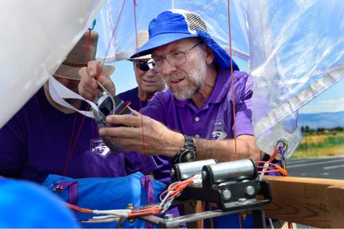Scott Sommerdorf   |  The Salt Lake Tribune
John Sohl, right, attaches a camera to the instruments payload of the seater balloon prior to one of their morning launches, Thursday, July 16, 2015.  WSU and the U are conducting a joint study on the impact of the Great Salt Lake on ozone levels on the Wasatch Front. Previous studies have found that salt from the Great Salt Lake contributes to a lot of our wintertime PM 2.5 pollution. The theory is that maybe the lake also contributes to ozone.