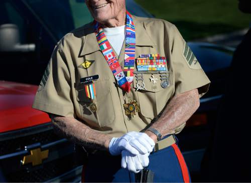 Scott Sommerdorf   |  The Salt Lake Tribune
Marine veteran Sgt. John Cole smiles as he awaits the beginning of the ceremony to honor 22 veterans whose remains have never been claimed. They were interred in a service at the state veterans cemetery in Bluffdale, Saturday, August 1, 2015.