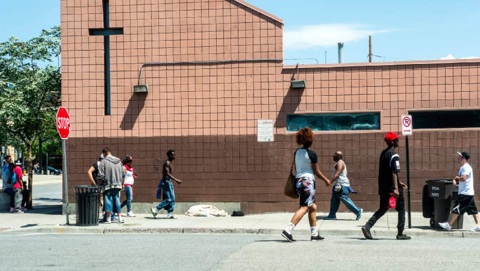Chris Detrick  |  The Salt Lake Tribune
Men and women walk past the Catholic Community Services in Salt Lake City Tuesday August 4, 2015.