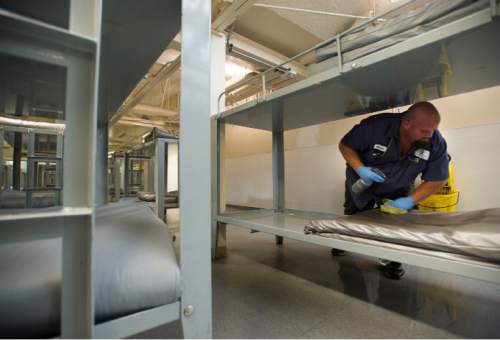 Steve Griffin  |  The Salt Lake Tribune

Darrin Jackson, who works in operations at the Road Home in Salt Lake City, cleans a bunk in the men's sleeping area Thursday, August 6, 2015.
