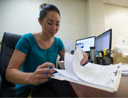 Steve Griffin  |  The Salt Lake Tribune

Housing specialist, Natalie Shewell, works on a client's file at the Road Home in Salt Lake City Thursday, August 6, 2015.