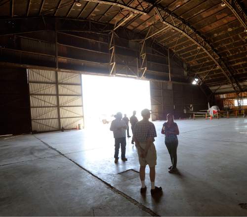 Al Hartmann  |  The Salt Lake Tribune
A tour group looks inside the "Enola Gay" hangar at Wendover Airfield.  It's one of the last remaining hangars and is partially restored.
The Enola Gay, piloted by Col. Paul Tibbets, dropped the first atomic bomb on Hiroshima, Japan, on Aug. 6, 1945. Three days later, the bomb Fat Man was dropped on Nagasaki. The long-disance bombers trained at Wendover Airfield. The bombings brought a swift end to war with Japan, but it was only later that the people of Wendover realized that their air base had housed the U.S. Army Air Force group that dropped the bomb, the 509th Composite Group. Tibbets was commander of the group that trained at Wendover and practiced with test bombs on the surrounding ranges.