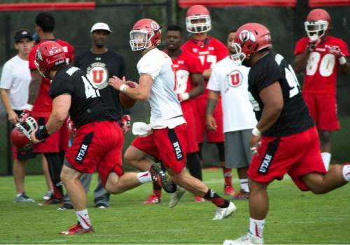 Steve Griffin  |  The Salt Lake Tribune

University of Utah quarterback Travis Wilson scrambles out of the pocket during second day of fall football camp at the University of Utah baseball field in Salt Lake City, Friday, August 7, 2015.