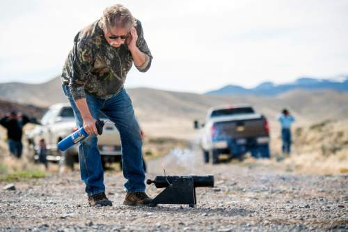 Chris Detrick  |  The Salt Lake Tribune
Robert Kirby lights a cannon armed with a cement-filled coke can aimed at a clothes washer in Rush Valley Saturday March 21, 2015.