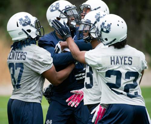 Steve Griffin  |  The Salt Lake Tribune

USU wide receiver Braelon Roberst gets swallowed up by the Aggie defense during opening day of Utah State University football practice in Logan, Friday, August 7, 2015.  l