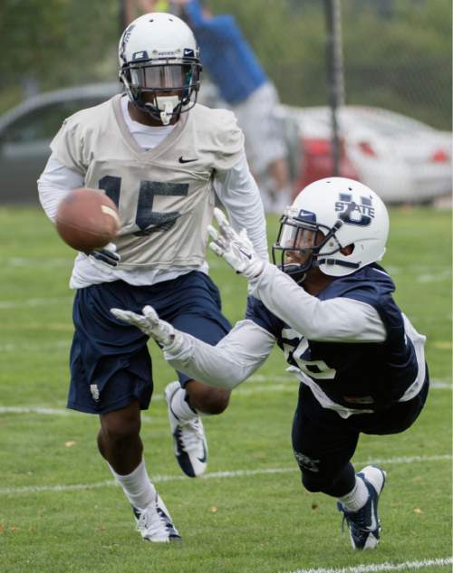 Steve Griffin  |  The Salt Lake Tribune

USU wide receiver Devonte Robinson hauls in a pass during opening day of Utah State University football practice in Logan, Friday, August 7, 2015.  l