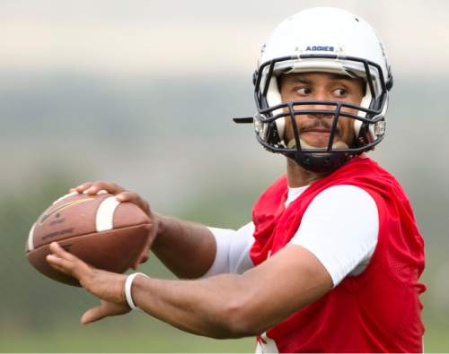 Steve Griffin  |  The Salt Lake Tribune

Utah State quarterback Chuckie Keeton throws downfield during opening day of football practice in Logan, Friday, August 7, 2015.  l