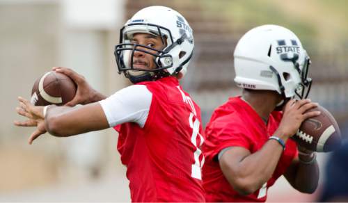 Steve Griffin  |  The Salt Lake Tribune

Utah State quarterback Chuckie Keeton throws passes  during opening day of football practice in Logan, Friday, August 7, 2015.  l