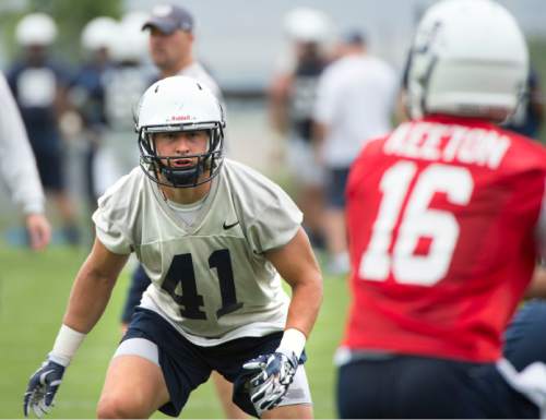 Steve Griffin  |  The Salt Lake Tribune

USU linebacker Nick Vigil eyes quarterback Chuckie Keeton during opening day of Utah State University football practice in Logan, Friday, August 7, 2015.  l