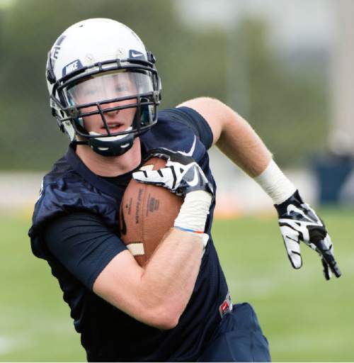 Steve Griffin  |  The Salt Lake Tribune

USU wide receiver Zach Van Leeuwan tacks the ball in after catching pass during opening day of Utah State University football practice in Logan, Friday, August 7, 2015.  l