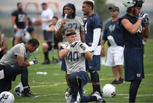 Steve Griffin  |  The Salt Lake Tribune

USU players stop for a snack during opening day of Utah State University football practice in Logan, Friday, August 7, 2015.  l