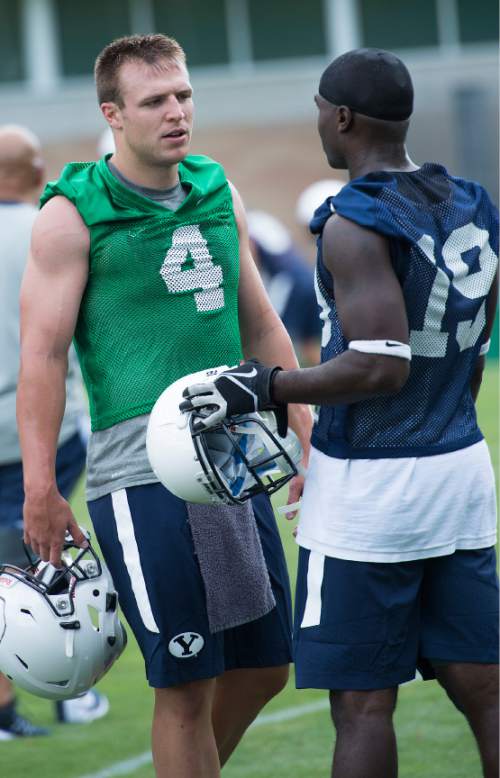 Leah Hogsten  |  The Salt Lake Tribune
Quarterback Taysom Hill talks with  wide receiver Devon Blackmon during Brigham Young University's first practice of fall football camp, August 8, 2015.