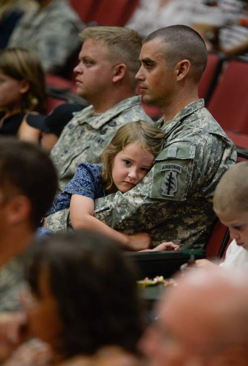 Francisco Kjolseth | The Salt Lake Tribune
Captain Jonathan Bingham holds his daughter Beatrix, 5, during the departure ceremony for 26 Soldiers of the Utah Army National Guard's 19th Special Forces (Airborne) on Monday, Aug. 10, at the Scott Lundell Readiness Center auditorium at Camp Williams. The mission of these Soldiers is to provide operational support to coalition forces involved in support of Operation Inherent Resolve in Afghanistan during a 12-month deployment.