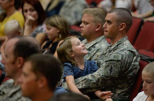 Francisco Kjolseth | The Salt Lake Tribune
Captain Jonathan Bingham holds his daughter Beatrix, 5, during the departure ceremony for 26 Soldiers of the Utah Army National Guard's 19th Special Forces (Airborne) on Monday, Aug. 10, at the Scott Lundell Readiness Center auditorium at Camp Williams. The mission of these Soldiers is to provide operational support to coalition forces involved in support of Operation Inherent Resolve in Afghanistan during a 12-month deployment.