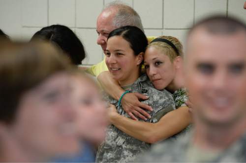 Francisco Kjolseth | The Salt Lake Tribune
Staff Sgt. Stephanie Lewis is surrounded by family as she poses for photos following the departure ceremony for 26 Soldiers of the Utah Army National Guard's 19th Special Forces (Airborne) on Monday, Aug. 10, at the Scott Lundell Readiness Center auditorium at Camp Williams.