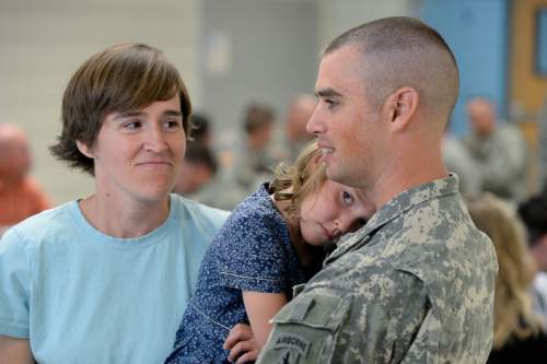 Francisco Kjolseth | The Salt Lake Tribune
Mitzi Bingham, left, faces a third deployment of her husband Captain Jonathan Bingham, holding their daughter Beatrix, 5, following the departure ceremony for 26 Soldiers of the Utah Army National Guard's 19th Special Forces (Airborne) on Monday, Aug. 10, at the Scott Lundell Readiness Center auditorium. The mission of these Soldiers is to provide operational support to coalition forces involved in support of Operation Inherent Resolve in Afghanistan during a 12-month deployment.