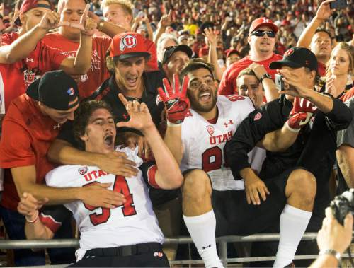 Rick Egan  |  The Salt Lake Tribune

Utah long snapper Chase Dominguez (94) and tight end Westlee Tonga (80) celebrate with Utah fans, as the Utes held on for a 30-28 upset over UCLA, in Pac 12 action, at the Rose Bowl, Saturday, October 4, 2014