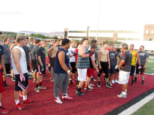 Tom Wharton  |  The Salt Lake Tribune

Hurricane players enjoy a late evening workout on the turf.