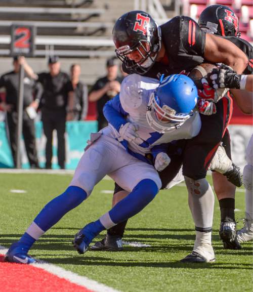 Trent Nelson  |  The Salt Lake Tribune
Hurricane's Jeremiah Ieremia powers past Dixie's Ryan Wilgar (1) for a touchdown as Hurricane faces Dixie High School in the 3AA state championship game at Rice-Eccles Stadium in Salt Lake City Friday November 21, 2014.