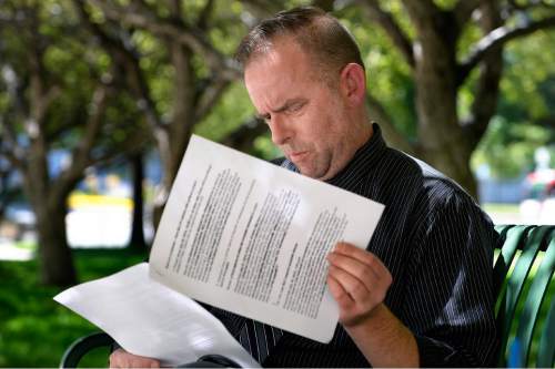 Scott Sommerdorf   |  The Salt Lake Tribune
Mayor Becker's spokesman Art Raymond looks over a transcript of comments he has made while commenting on Trib message boards disparaging Becker opponents using his "Whiskey Pete" pseudonym. He talked to the Tribune about it on the grounds of the City and County Building, Thursday, July 30, 2015.