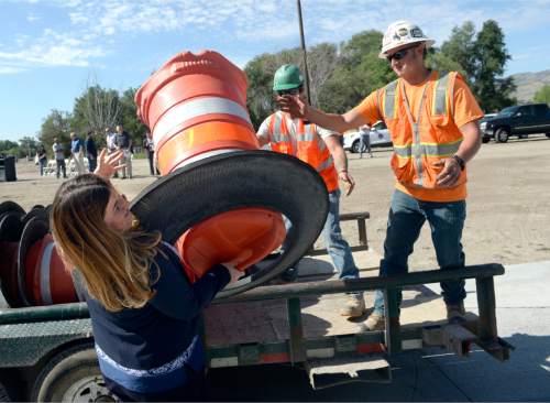 Al Hartmann  |  Tribune file photo
The freewaylike interchange at Bangerter Highway and Redwood Road is now open.  Bluffdale Councilwoman Heather Pehrson throws some of the last of the orange construction barrels to workers to open the intersection Thursday, July 16.
