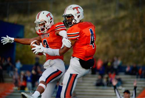 Scott Sommerdorf  |  The Salt Lake Tribune
Timpview WR Jordan Espinoza, left, helps celebrate WR Samson Nacua's TD during first half play. Timpview beat Sky View of Smithfield, 45-8 in a 4A state quarterfinal playoff game Friday, November 7, 2014 in Provo.
