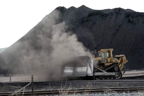 Francisco Kjolseth  |  The Salt Lake Tribune 
Crews move coal at the Levan transfer facility along Interstate 15 south of Nephi where a steady flow of trucks unload it before it is transferred to train cars. Utah's Community Impact Board has awarded a $53 million loan to four coal-producing counties to invest in a deep-water port in Oakland, Calif. hoping to connect central Utah commodities with export markets. Bowie Resource Partners already exports about 1 to 3 million tons of coal from its Utah mines.