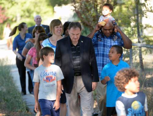 Al Hartmann  |  The Salt Lake Tribune                                                                                                                    Utah Governor Gary Herbert takes a practice walk with Highland Park Elementary School parents and students in Salt Lake City Thursday August 13 to get ready for the upcoming school year.  He wants them to ditch carpools and set up walking school bus groups using UDOT's Walking School Bus App.  The app allows parents to coordinate walking groups to and from school and notifies them when  children have arrived safely.