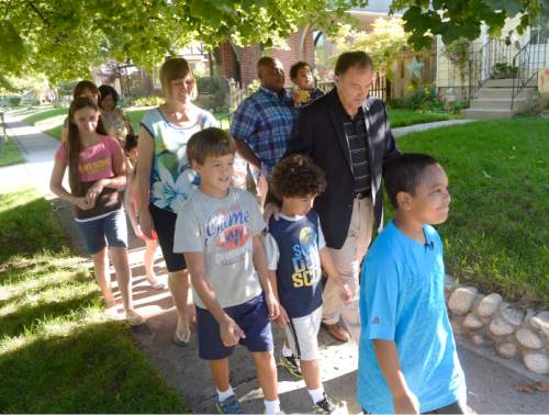 Al Hartmann  |  The Salt Lake Tribune                                                                                                                    Utah Governor Gary Herbert takes a practice walk with Highland Park Elementary School parents and students in Salt Lake City Thursday August 13 to get ready for the upcoming school year.  He wants them to ditch carpools and set up walking school bus groups using UDOT's Walking School Bus App.  The app allows parents to coordinate walking groups to and from school and notifies them when  children have arrived safely.