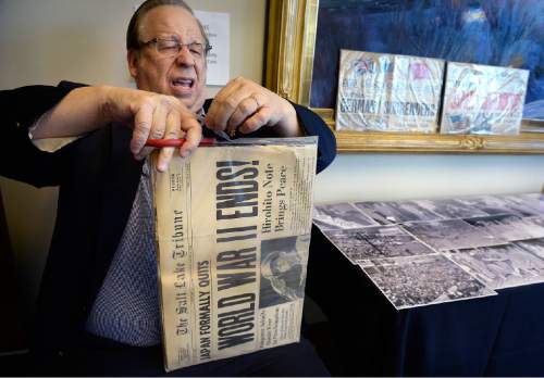 Scott Sommerdorf   |  The Salt Lake Tribune
Historian Ron Fox cuts open the protective envelope around the Aug. 15, 1945, edition of The Salt Lake Tribuneso it can be photographed during Fort Douglas Military Museum's VJ Day program, 1945: The Year That Changed The World, on Saturday, Aug. 15, 2015.