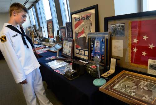 Scott Sommerdorf   |  The Salt Lake Tribune
U.S. Naval Cadet Cody Overacker looks over a collection of WWII artifacts during the Fort Douglas Military Museum's V.J. Day program -- 1945: The Year That Changed The World, Saturday, August 15, 2015.