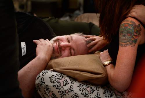 Scott Sommerdorf   |  The Salt Lake Tribune
Steve Afrin has his hair stroked by Jenny Evans during during "cuddle party" - a regular meet-up that happens in Utah, where strangers get together and cuddle in a nonsexual way, Friday, July, 31, 2015.