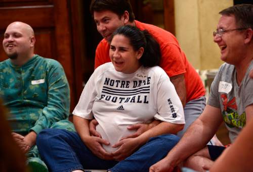 Scott Sommerdorf   |  The Salt Lake Tribune
Doug Roberts, top and Emily Roberts met during another cuddle party, and now she is expecting. "Cuddle party" is a regular meet-up that happens in Utah, where strangers get together and cuddle in a nonsexual way, Friday, July, 31, 2015.