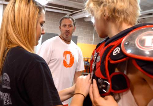 Leah Hogsten  |  The Salt Lake Tribune
Coach Kent Taylor talks with sophomore player Ashton Loosli who is fitted with pads and helmet after practice Wednesday, June 10, 2015. 
After last season's struggle, Ogden High School's  football program decided to play an independent schedule for the next two years.