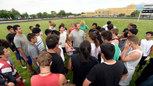 Al Hartmann |  The Salt Lake Tribune
Ogden High School football coach Kent Taylor, center, circles his players for a final talk after a summer conditioning workout Thursday June 11, 2015.  The team belongs in Class 4A purely by enrollment numbers, but the football program argued during recent UHSAA realignment meetings that, based on a historic lack of competitiveness, it should be dropped down a classification or two to allow the program to rebuild.