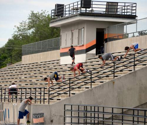 Al Hartmann |  The Salt Lake Tribune
Next season's Ogden High School football team players crab walk down stadium stairs during a summer conditioning workout Thursday June 11, 2015. The team belongs in Class 4A purely by enrollment numbers, but the football program argued during recent UHSAA realignment meetings that, based on a historic lack of competitiveness, it should be dropped down a classification or two to allow the program to rebuild.