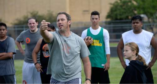 Al Hartmann |  The Salt Lake Tribune
Ogden High School football coach Kent Taylor encourages his players during a summer conditioning workout Thursday June 11, 2015. The team belongs in Class 4A purely by enrollment numbers, but the football program argued during recent UHSAA realignment meetings that, based on a historic lack of competitiveness, it should be dropped down a classification or two to allow the program to rebuild.