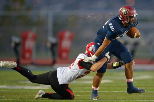 Chris Detrick  |  The Salt Lake Tribune
 Herriman's Tomasi Tonga (32) is tackled by American Fork's Benjamin Cummings (20) during the game at Herriman High School Friday October 3, 2014.