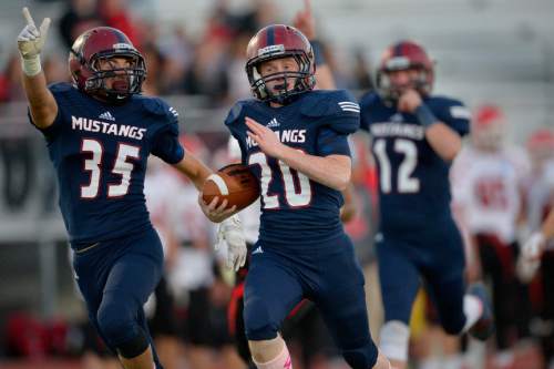 Chris Detrick  |  The Salt Lake Tribune
Herriman's Brig Rush (20) runs for a touchdown as teammates  Jake Reynolds (35) and Cody Eldredge (12) celebrate during the game at Herriman High School Friday October 3, 2014.